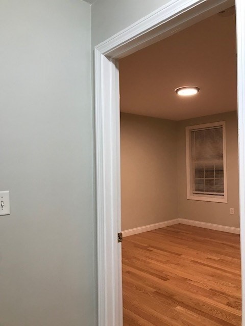 157-159 Fuller Street Boston, MA 02124 - Photo 10 of 19 a view of an empty room with wooden floor