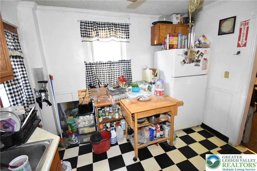 22 South Raspberry Street Easton, PA 18042 - Photo 5 of 16 a kitchen with a stove a refrigerator and a dining table