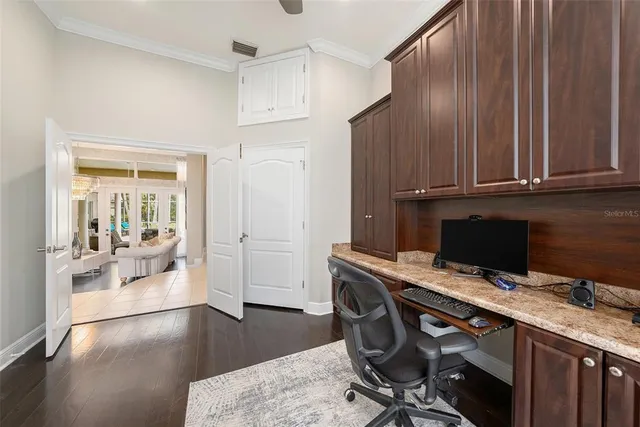 a kitchen with stainless steel appliances kitchen island granite countertop a stove and cabinets
