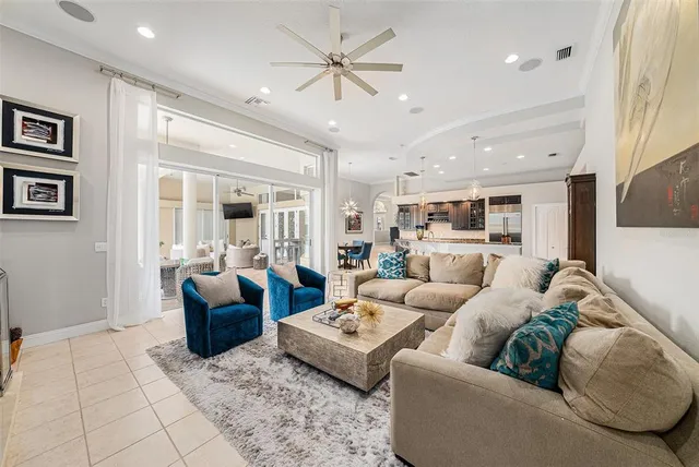 a living room with furniture and view of kitchen