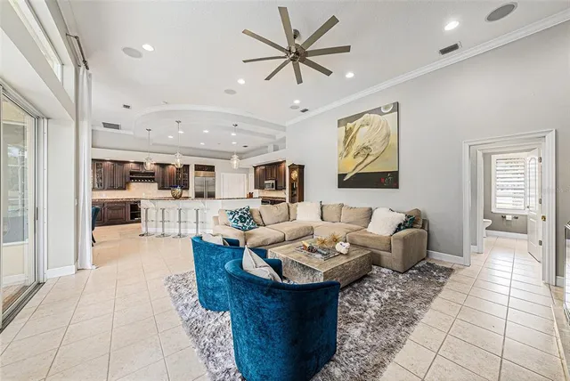 a living room with fireplace furniture and a chandelier