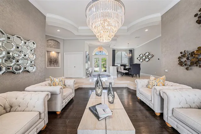 a living room with furniture and a chandelier