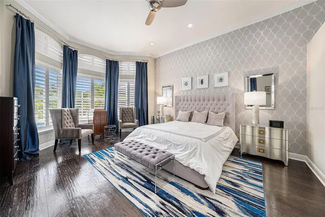 a room with a bed and a potted plant