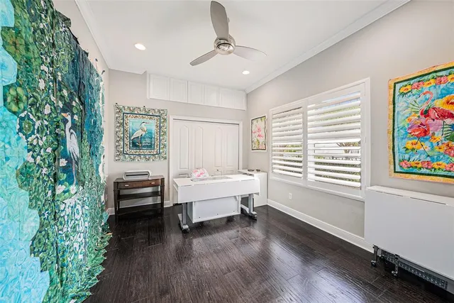 a bedroom with a bed a chair and a large window