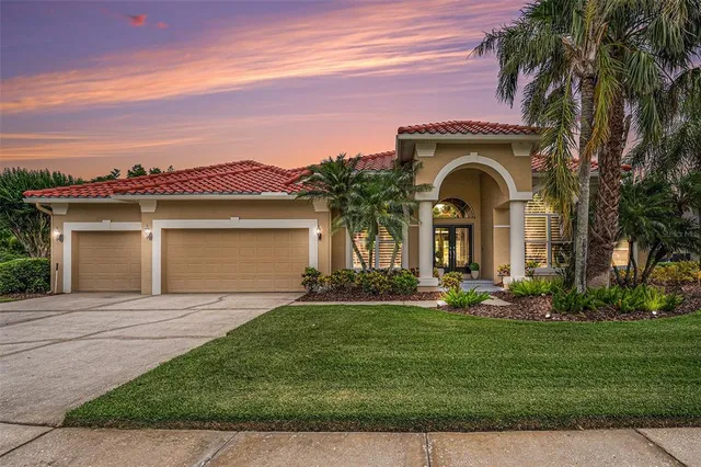 a front view of a house with a garden and yard