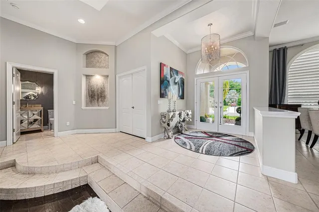 a living room with furniture and a chandelier