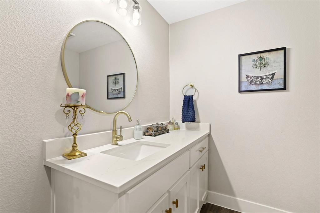 114 West Morton Street Denison, TX 75021 - Photo 13 of 21 a bathroom with a sink and a mirror