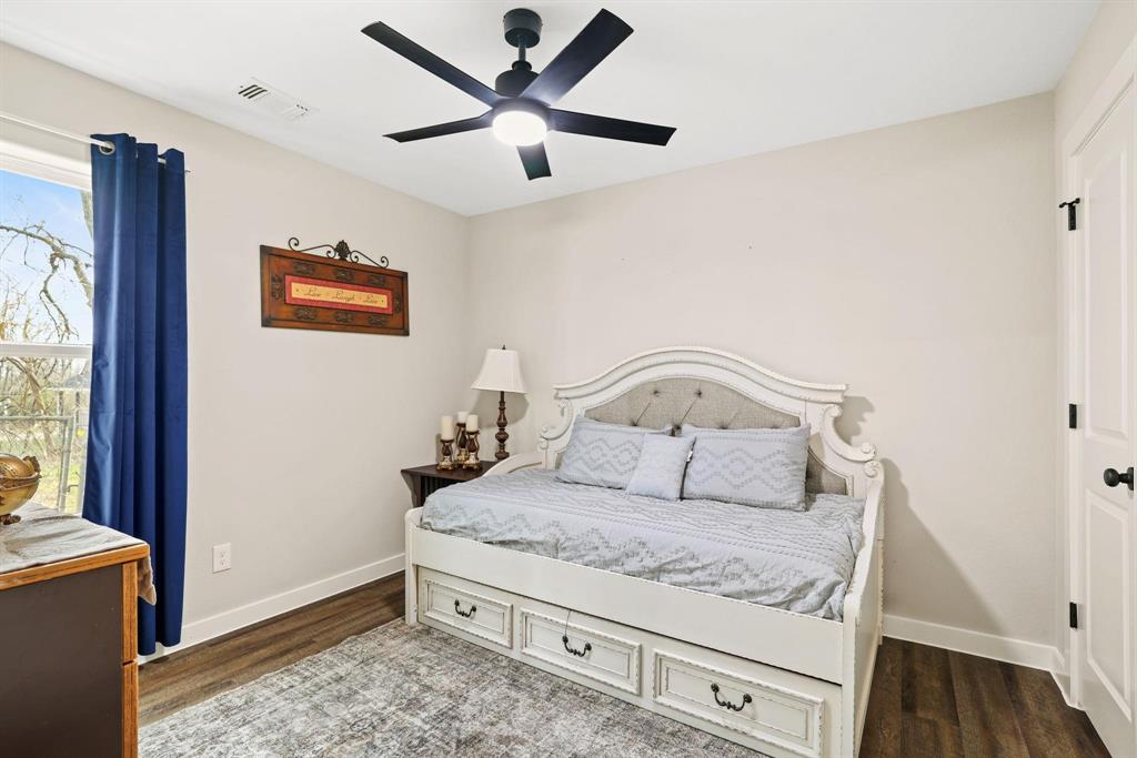 114 West Morton Street Denison, TX 75021 - Photo 18 of 21 a bedroom with a bed and a window