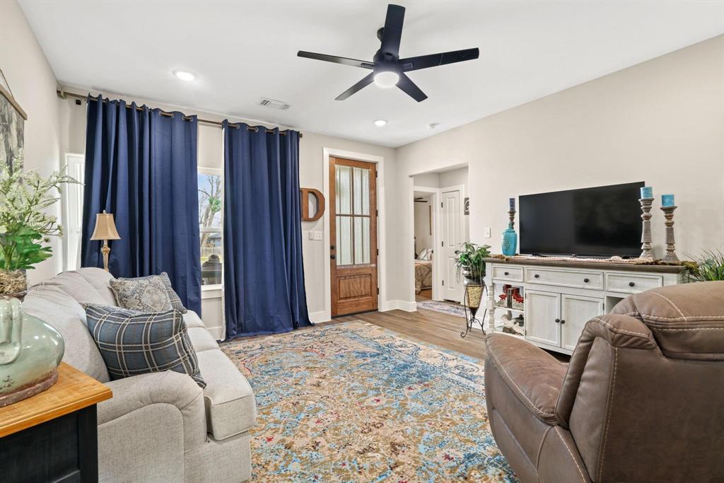 114 West Morton Street Denison, TX 75021 - Photo 3 of 21 a living room with furniture and a flat screen tv