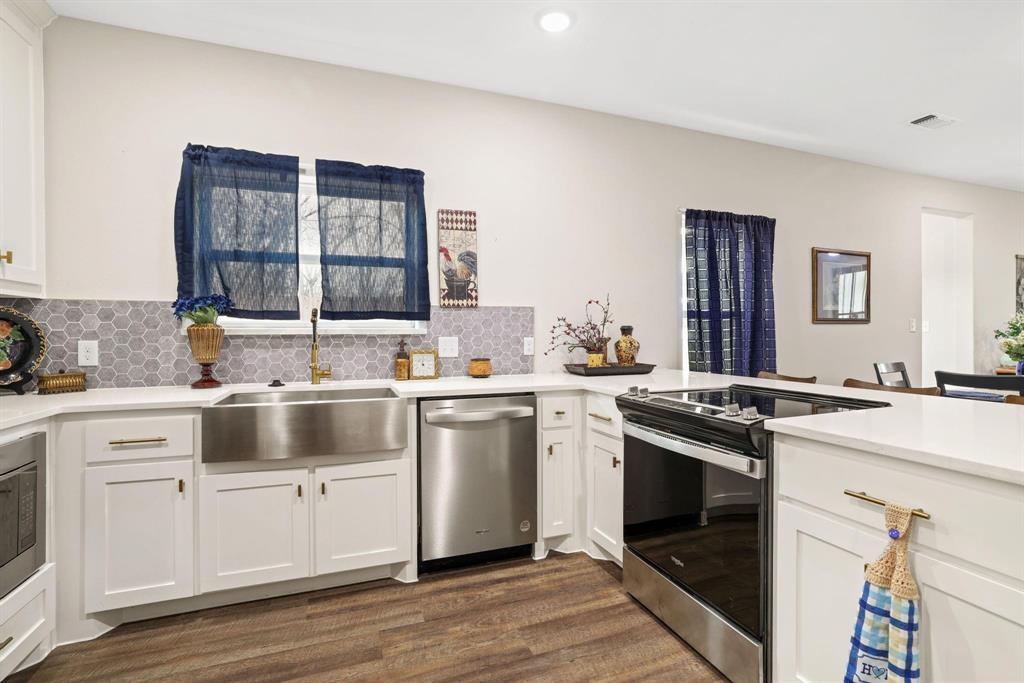 114 West Morton Street Denison, TX 75021 - Photo 6 of 21 a kitchen with a stove oven and sink