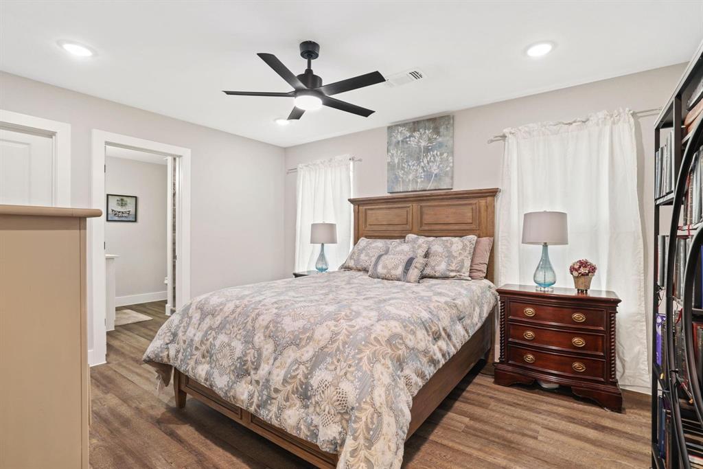 114 West Morton Street Denison, TX 75021 - Photo 10 of 21 a bedroom with a bed and a chandelier