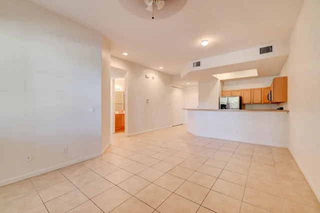 a view of a kitchen with kitchen island and natural light