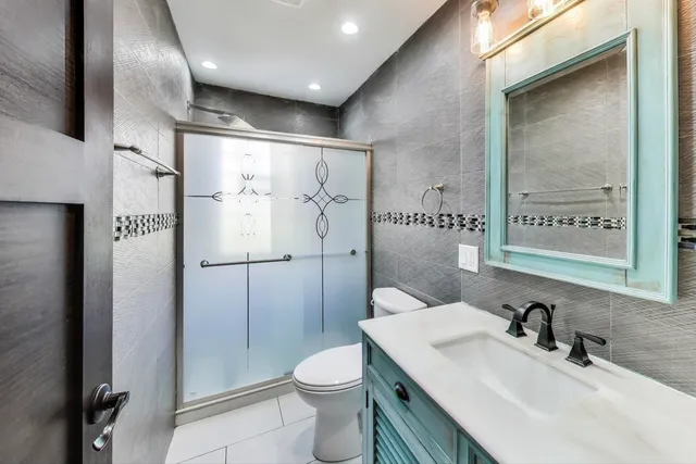 a large kitchen with stainless steel appliances granite countertop a large counter top a sink and dishwasher