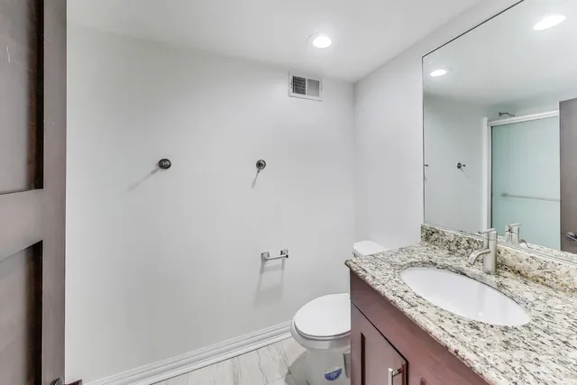 a bathroom with a glass shower door