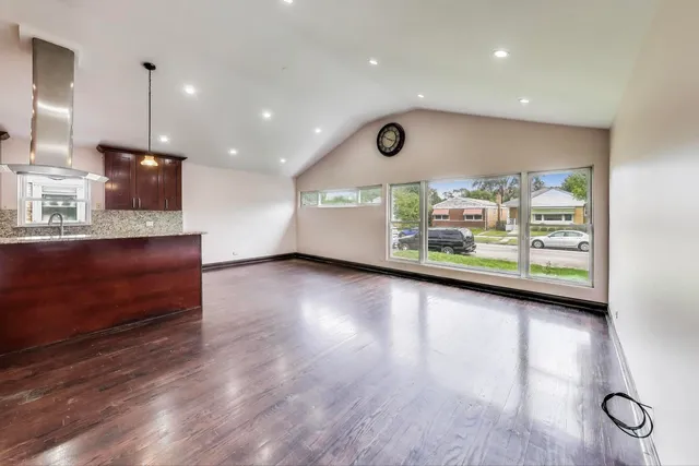 a view of room with window and wooden floor