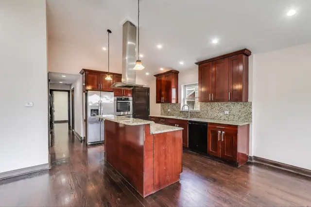 a kitchen with stainless steel appliances granite countertop a sink stove and refrigerator