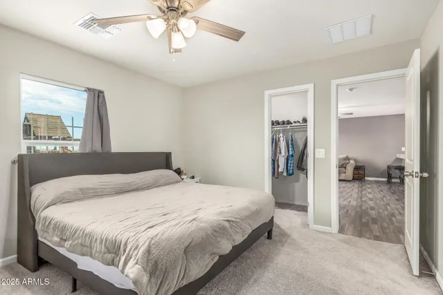 a bedroom with a bed and a chandelier
