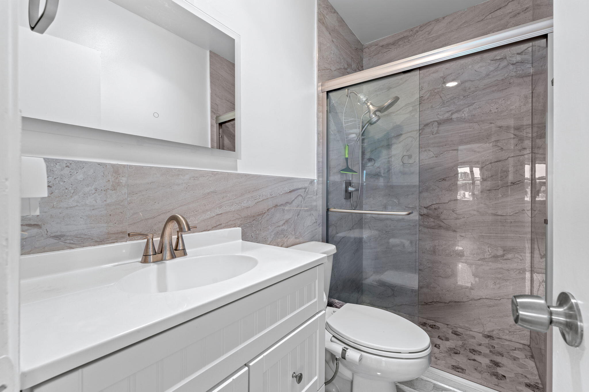 418 South Cypress Road, Unit 128 Pompano Beach, FL 33060 - Photo 22 of 49 a bathroom with a sink a toilet and shower