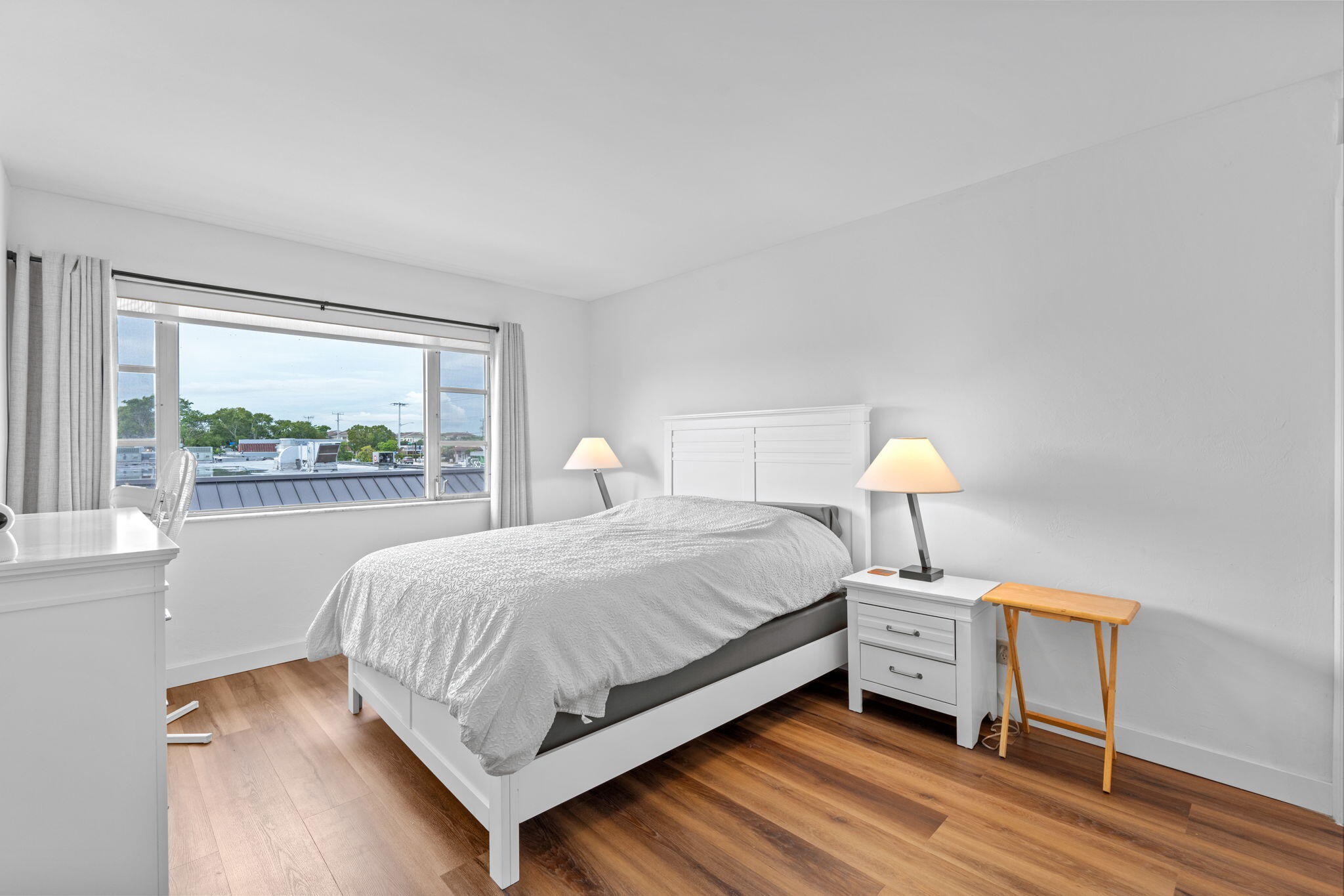 418 South Cypress Road, Unit 128 Pompano Beach, FL 33060 - Photo 24 of 49 a bedroom with a bed and a large window