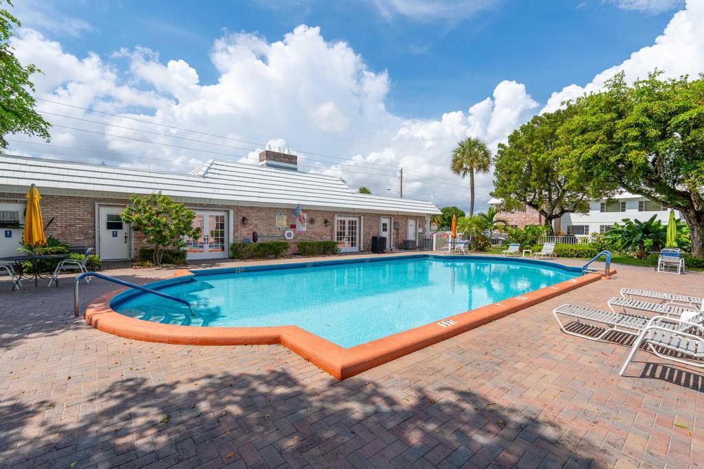 418 South Cypress Road, Unit 128 Pompano Beach, FL 33060 - Photo 41 of 49 a view of a swimming pool with a garden