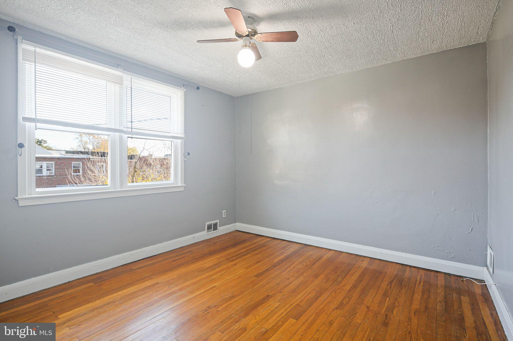 49 Briarwood Road Baltimore, MD 21228 - Photo 11 of 17 wooden floor in an empty room with a window