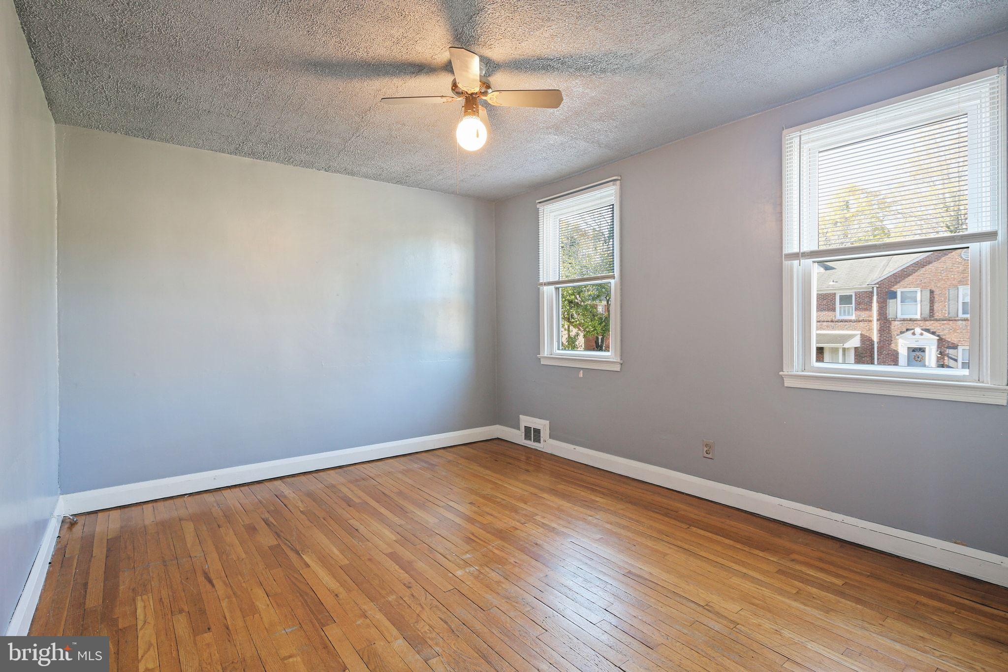 49 Briarwood Road Baltimore, MD 21228 - Photo 12 of 17 wooden floor in an empty room with a window