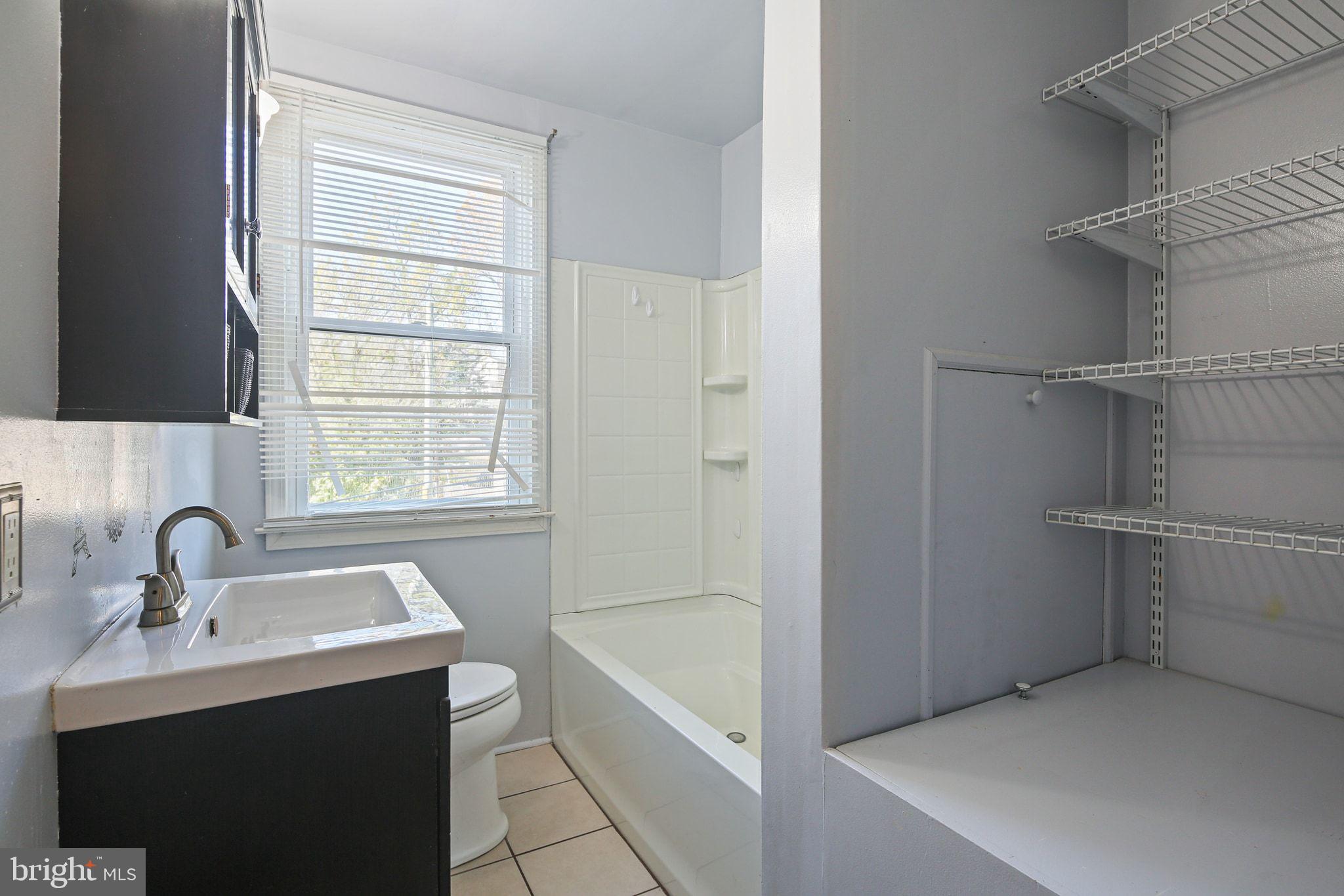 49 Briarwood Road Baltimore, MD 21228 - Photo 13 of 17 a bathroom with a sink and a bathtub