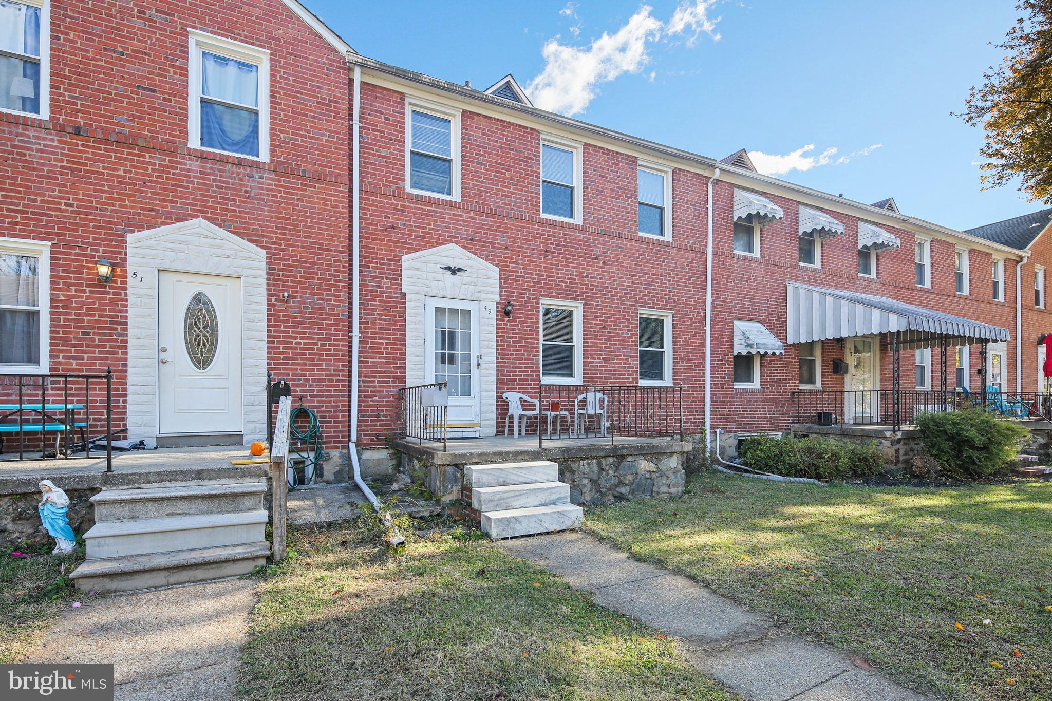 49 Briarwood Road Baltimore, MD 21228 - Photo 2 of 17 a front view of a house with yard and green space