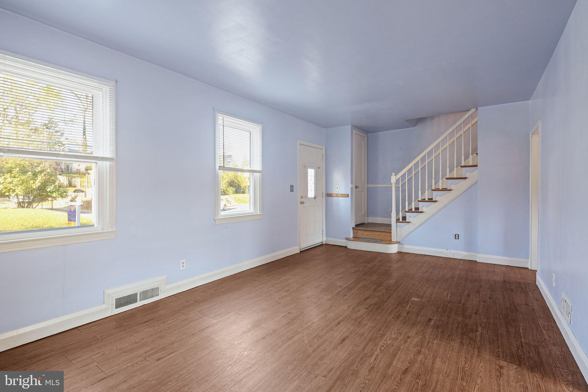 49 Briarwood Road Baltimore, MD 21228 - Photo 3 of 17 a view of an empty room with wooden floor and a window