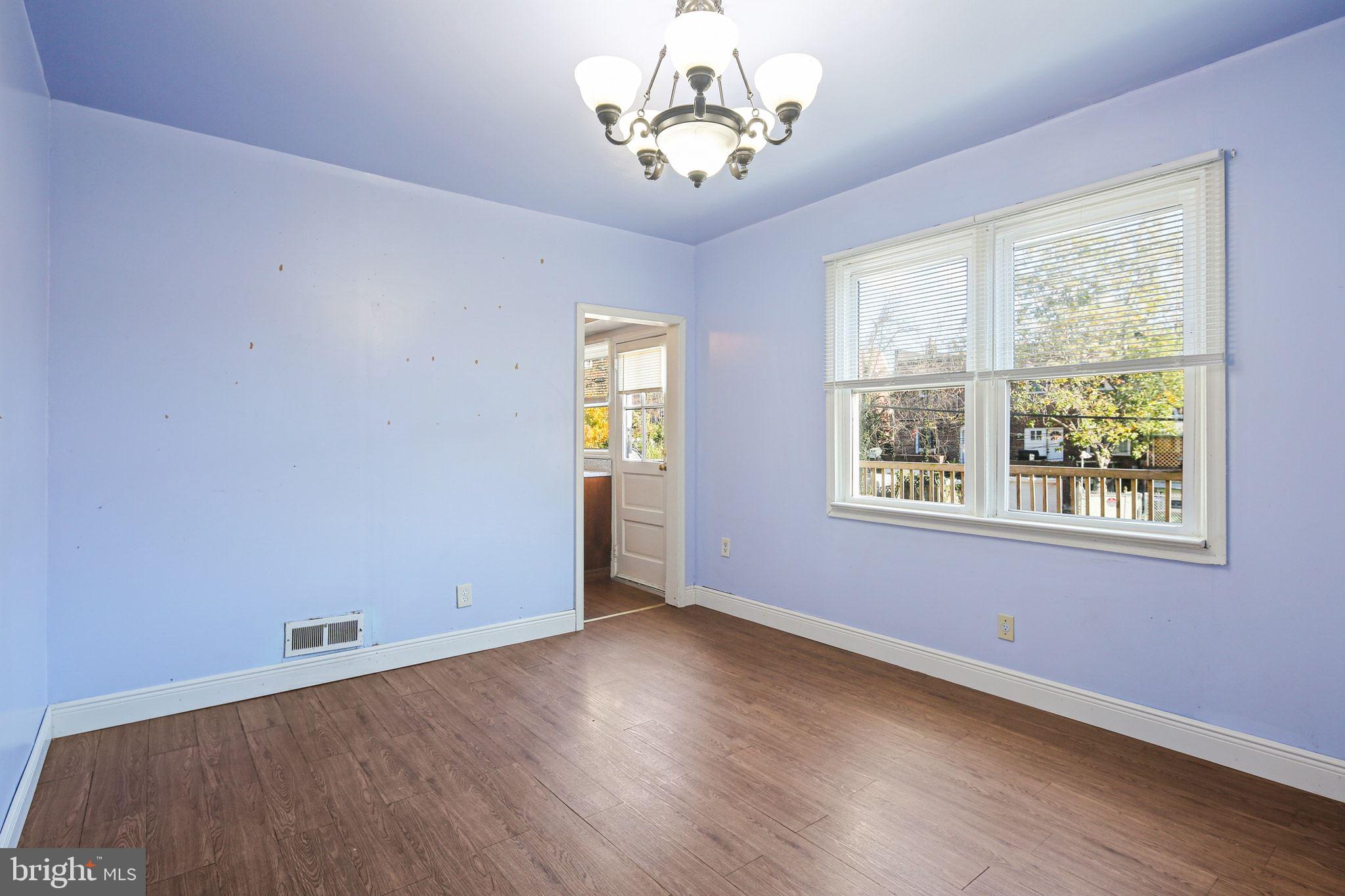 49 Briarwood Road Baltimore, MD 21228 - Photo 6 of 17 a view of a room with wooden floor and windows