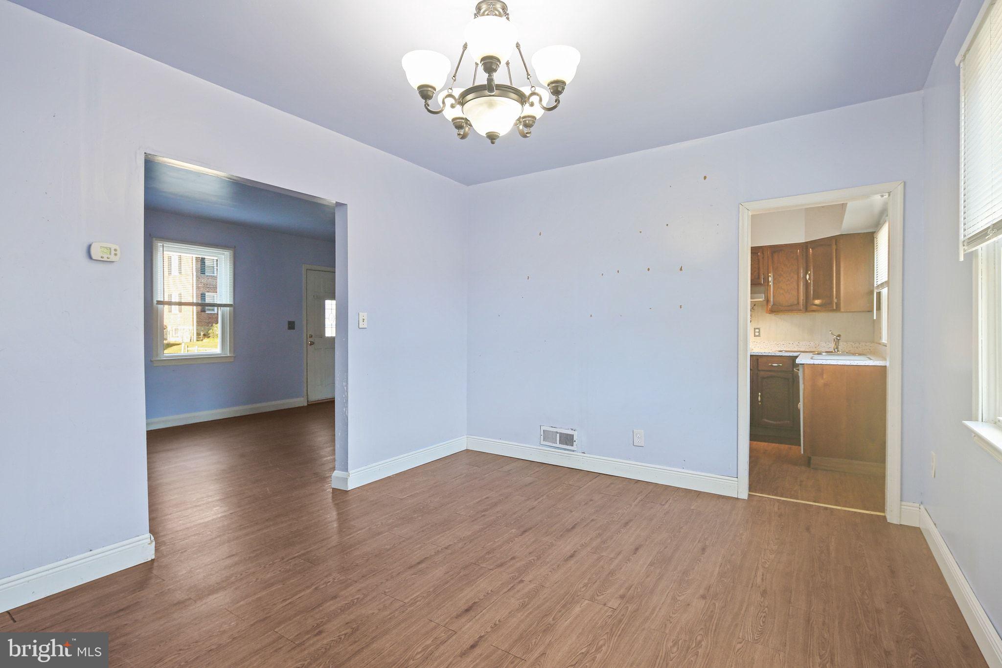 49 Briarwood Road Baltimore, MD 21228 - Photo 7 of 17 a view of a room with wooden floor and a chandelier