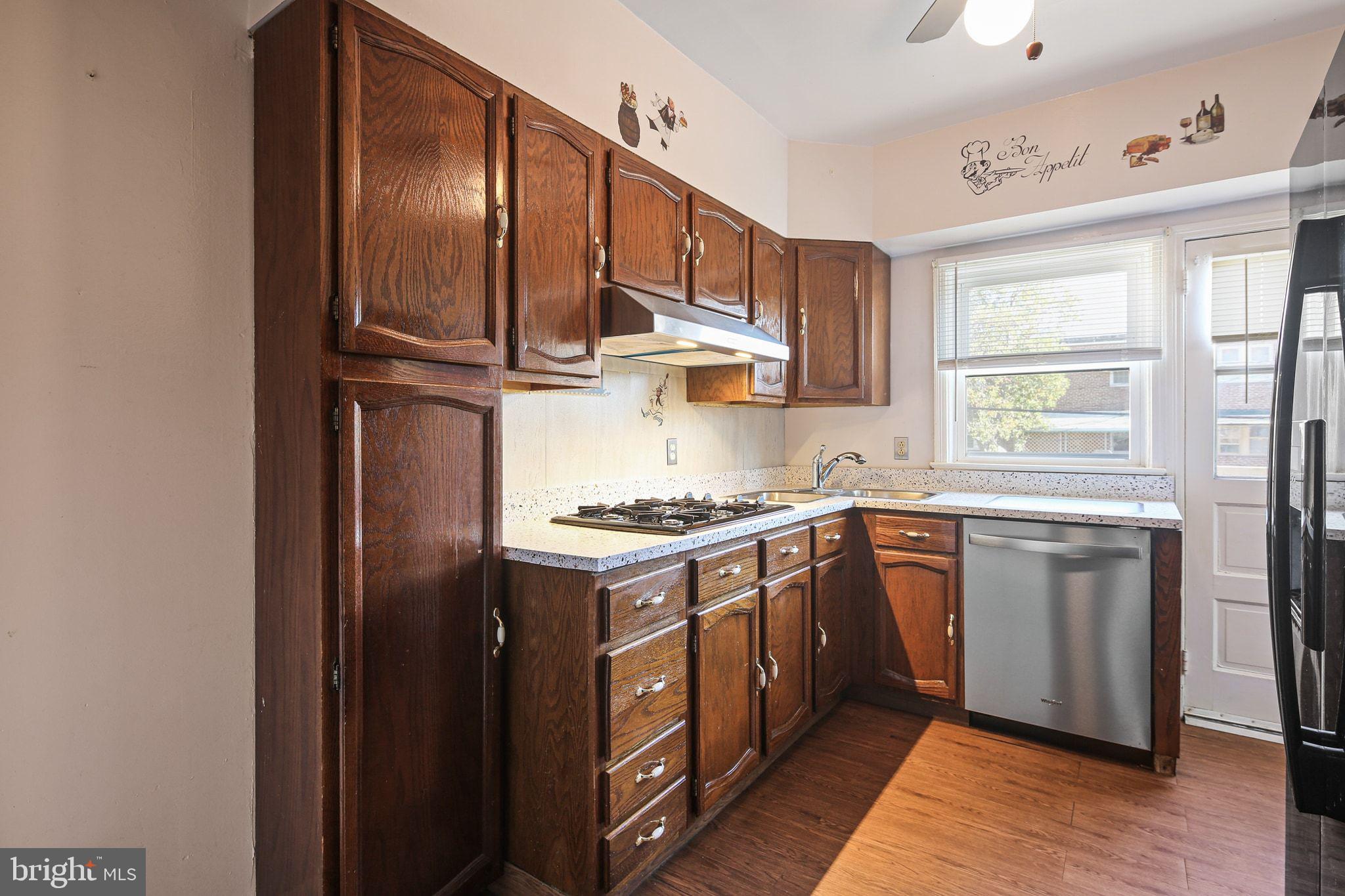 49 Briarwood Road Baltimore, MD 21228 - Photo 8 of 17 a kitchen with stainless steel appliances granite countertop a stove a sink dishwasher and a refrigerator