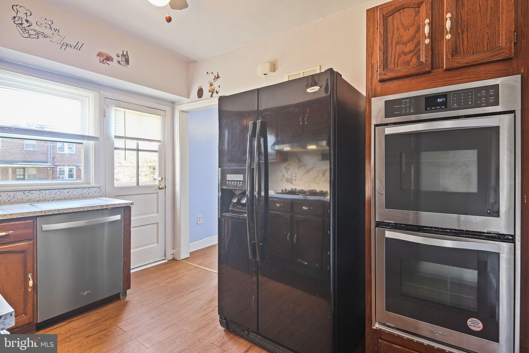 49 Briarwood Road Baltimore, MD 21228 - Photo 9 of 17 a kitchen with granite countertop white cabinets and stainless steel appliances