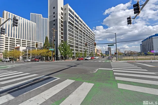 a city street lined with buildings and a yard
