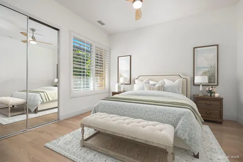 a bedroom with a large bed a chandelier and a window