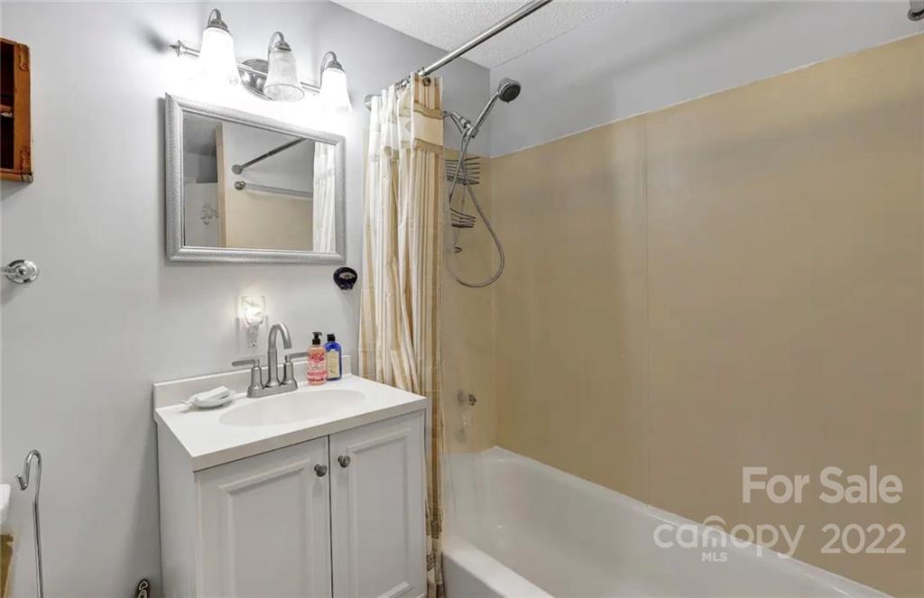 350 East Boiling Spring Road Southport, NC 28461 - Photo 5 of 15 a bathroom with a sink and a mirror