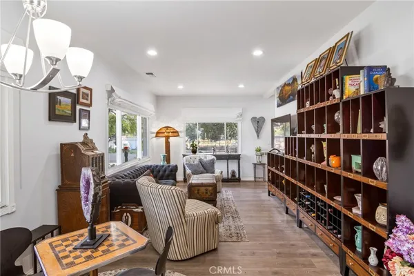 a living room with furniture a rug and a book shelf