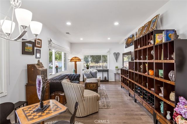 a living room with furniture a rug and a book shelf
