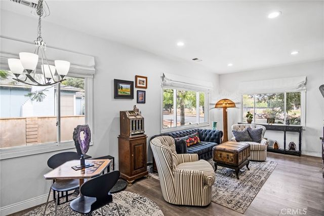 a living room with furniture a window and a chandelier