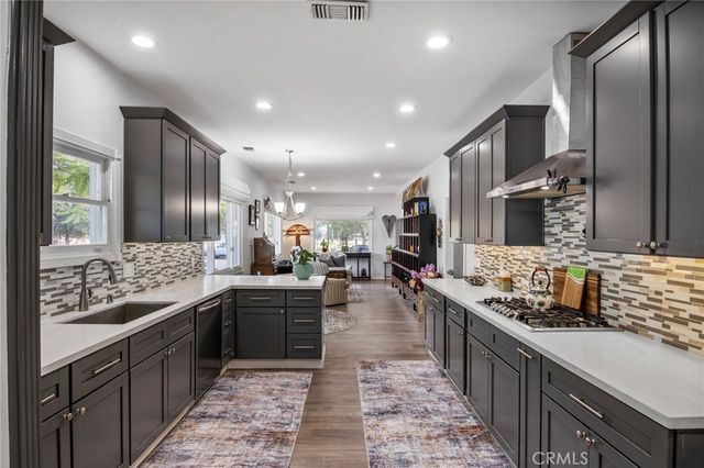 a large kitchen with stainless steel appliances lots of counter top space