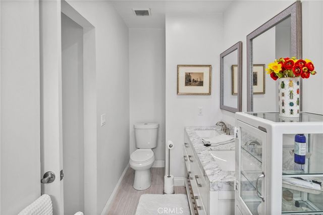 a bathroom with a sink mirror and vanity