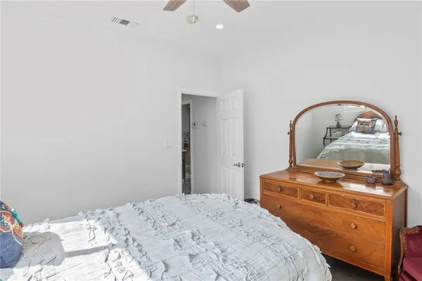 a bedroom with a bed and a dresser