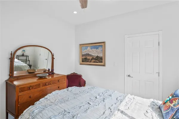 a bedroom with a bed and a dresser