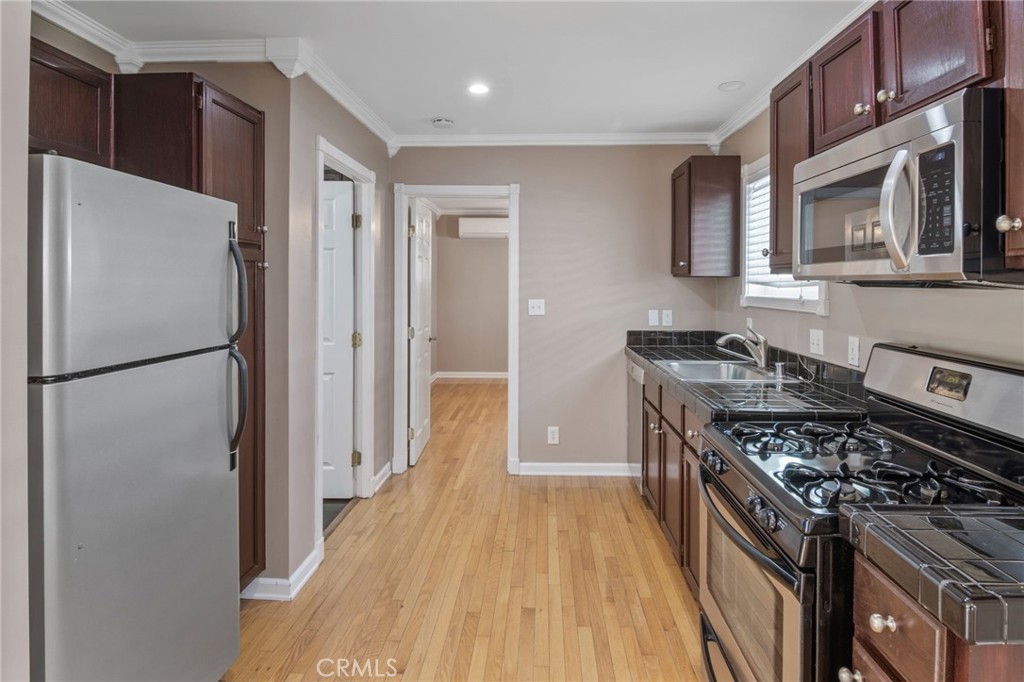 1007 Rose Avenue Pasadena, CA 91107 - Photo 37 of 52 a kitchen with stainless steel appliances granite countertop a refrigerator and a stove