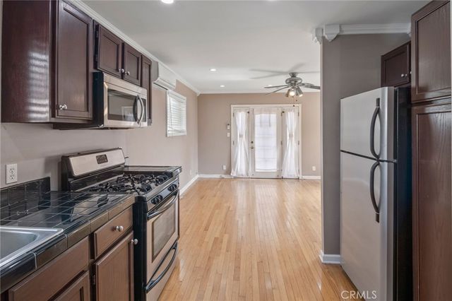 an empty room with a window and wooden floor