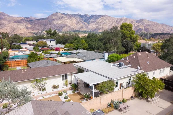 an aerial view of a house with yard garage and a city view