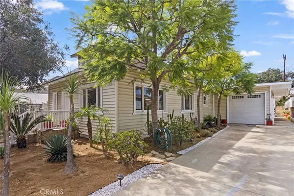 a view of a house with a tree in the background