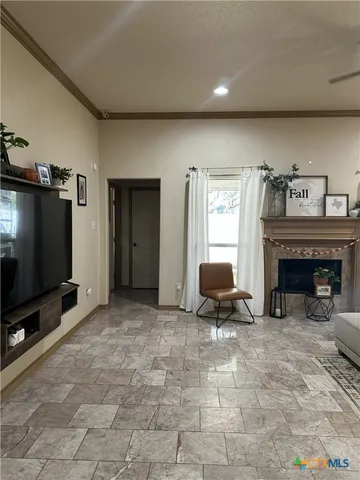 a living room with furniture and a flat screen tv