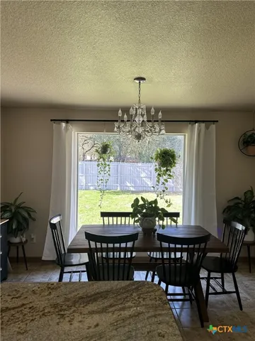a living room with furniture a mirror and a wooden floor