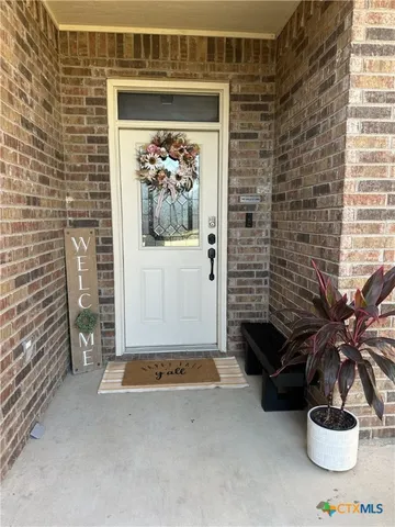 a view of a hallway with paintings on the wall